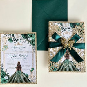 May include: Green and gold Quinceañera invitation with a green and gold glitter background. The invitation features a green and gold floral design with a butterfly and a young woman in a green dress. The text on the invitation reads "Mis Quince" and "Sophie Pantoja".