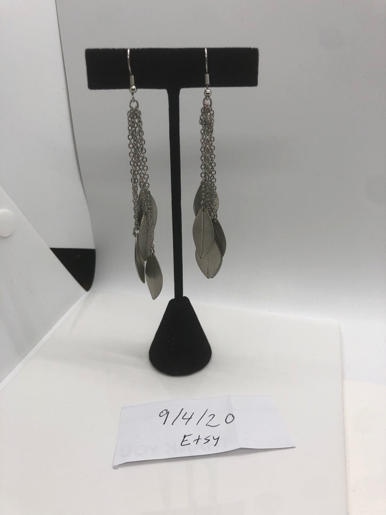 Ships USPS first class mail Vintage Silvertone dangle pierced earrings Pre owned.