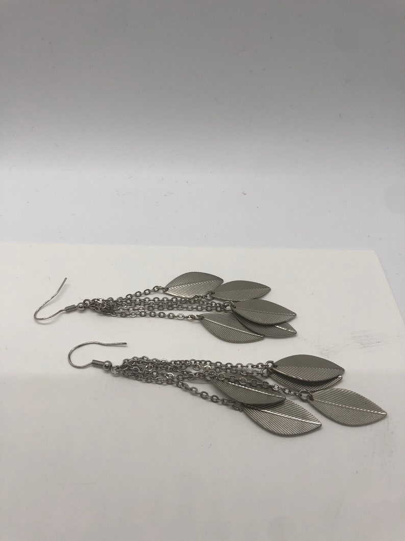 Ships USPS first class mail Vintage Silvertone dangle pierced earrings Pre owned.