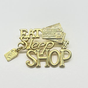 Vintage goldtone Eat Sleep Shop pin made by AJC