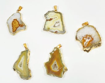 May include: Five agate slice pendants with gold-toned metal settings. Each pendant features a unique natural pattern of white, brown, and orange agate.