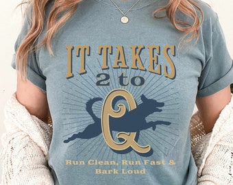 May include: A blue t-shirt with a graphic of two dogs running and the text "It Takes 2 to Q" and "Run Clean, Run Fast & Bark Loud".
