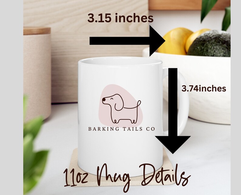 May include: White ceramic mug with a pink and brown illustration of a dachshund and the text "Barking Tails Co." The mug is 3.74 inches tall and 3.15 inches wide. It is a 11oz mug.