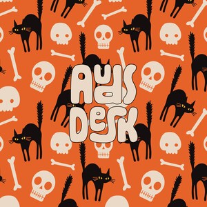 May include: A Halloween themed pattern with black cats, skulls, and crossbones on an orange background. The text "Ays Desk" is in the center of the pattern.