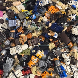 May include: A jumbled assortment of colorful Lego minifigures. The figures are in various poses and feature a range of colors, including blue, white, orange, and brown. Some figures have helmets and weapons.