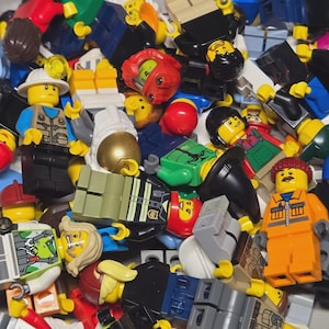 May include: A jumble of colorful Lego minifigures, featuring various professions and characters. The figures have yellow heads, with different hairstyles and facial expressions. Some wear hats, helmets, and uniforms, creating a diverse collection.