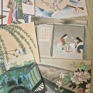 K&ouml;nnte beinhalten: Eine Sammlung rechteckiger Papierdrucke mit traditionellen japanischen Kunstmotiven, darunter eine Kutsche mit blauen Blumen, Weidenzweige, eine Szene mit zwei Personen an einem Webstuhl und ein F&auml;cherdesign mit Ahornbl&auml;ttern und Kalligrafie.