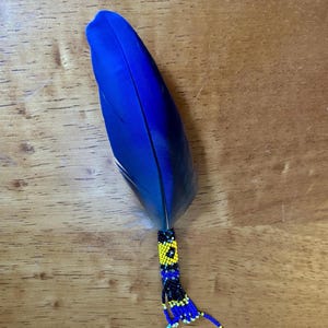 Small macaw parrot, beaded travel feather with matching beaded chain. Rearview mirror charm with palo santo smudge.