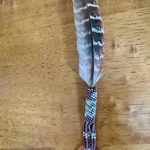 Small, beaded travel feather with matching chain, rearview mirror charm. Comes with cedar smudge.