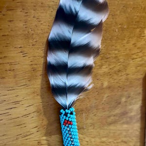 Mini, beaded travel feather or rearview mirror charm. Comes with cedar smudge.