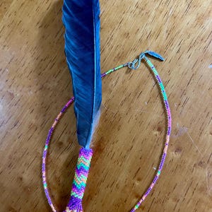 Small, black beaded feather with matching chain, rearview mirror charm. Comes with cedar smudge.