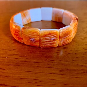 Thick cut, orange spiny oyster shell bracelet. Comfy elastic, wide fit.