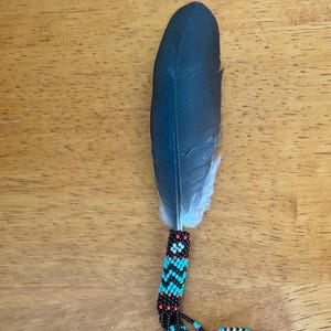 Small, black travel feather with matching beaded chain, rearview mirror charm. Comes with cedar smudge.