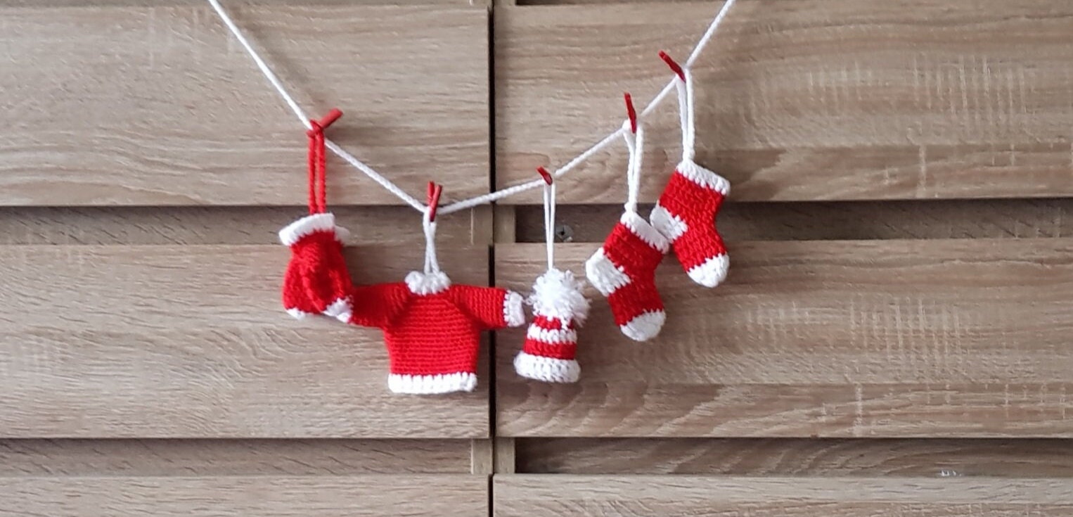 Clothesline made out of pvc plastic water pipes and thick yarn. Hung baby  girl clothes & socks with small clothes pins…