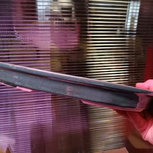 May include: A dark green ceramic bonsai pot with a light pink rim. The pot is oval shaped and has a smooth, glossy finish.