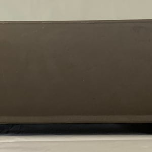 May include: A brown rectangular ceramic bonsai pot with a rounded base and four small feet.