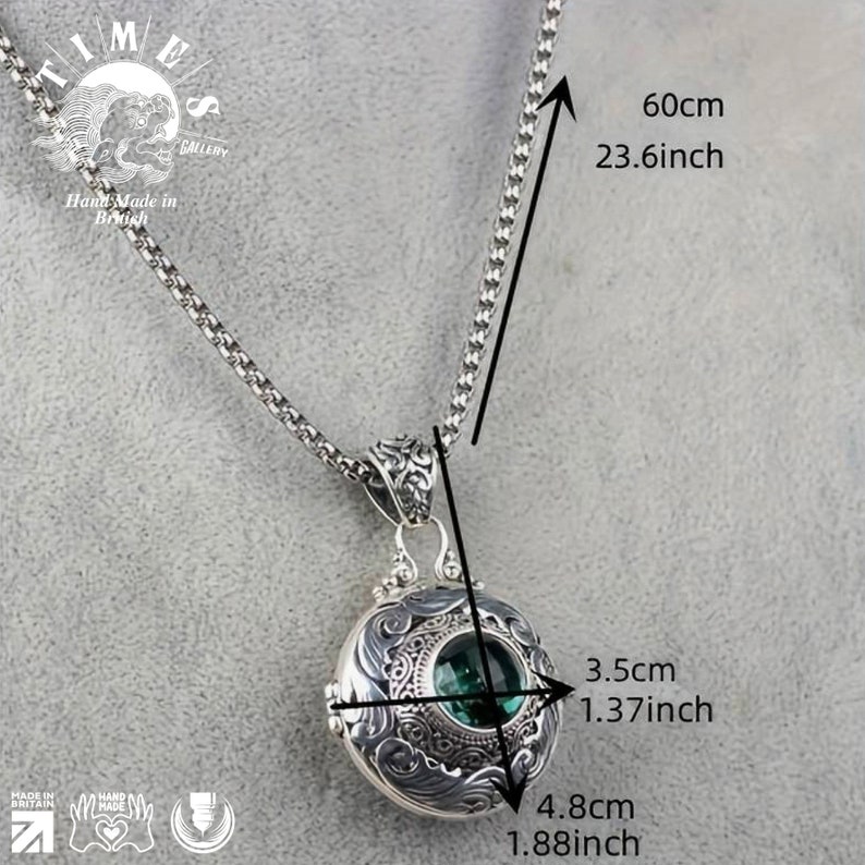 May include: A silver locket necklace with a detailed design and a green gemstone. The necklace is 23.6 inches long and the locket is 1.88 inches wide and 1.37 inches tall.