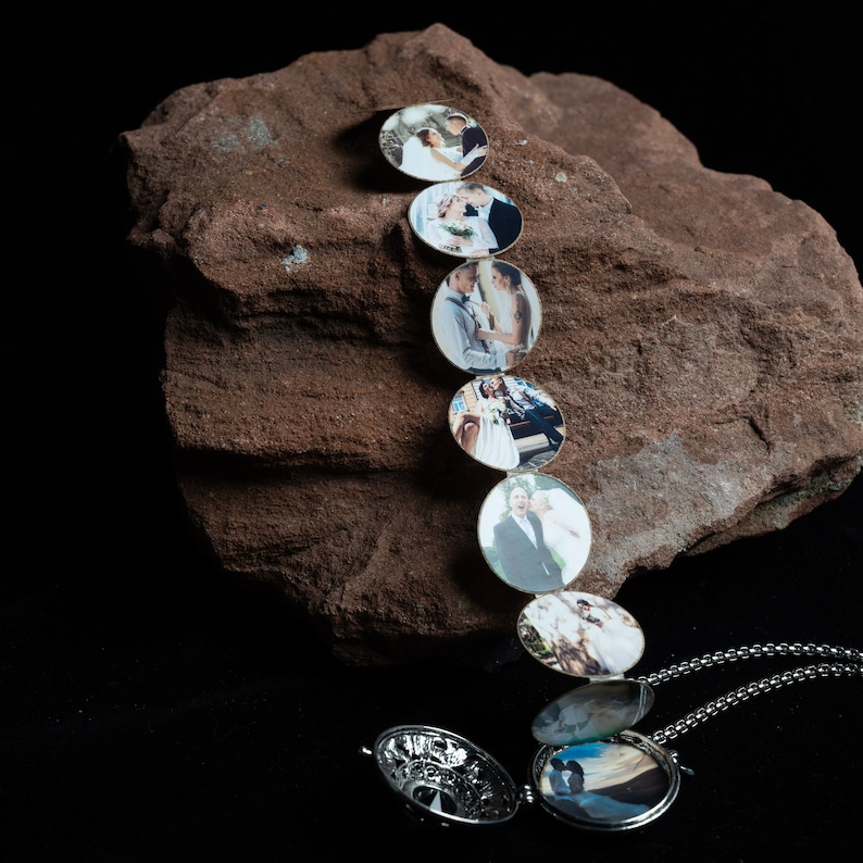 May include: A silver locket necklace with a chain. The locket opens to reveal a series of smaller lockets, each containing a different photo of a couple.