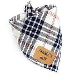 May include: A white, blue, and red plaid bandana with a brown leather patch that says "MAMA'S BOY" in black text.