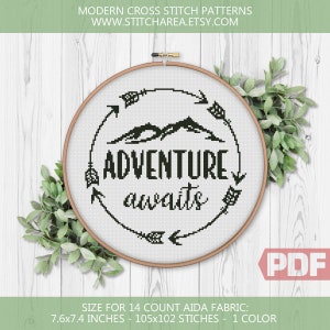 May include: Black and white cross stitch pattern with the text "Adventure awaits" in a circle with arrows pointing towards the text. The pattern is designed for 14 count Aida fabric and measures 7.6 x 7.4 inches, or 105 x 102 stitches.