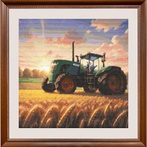 May include: A framed cross-stitch depicting a green tractor in a field of wheat at sunset. The tractor has large black tires and orange rims. The sky is a mix of orange, pink, and blue hues.