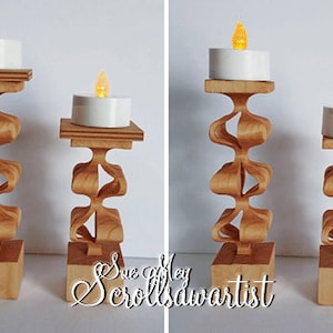May include: Three wooden candle holders with intricate scrollwork designs. The holders are different sizes and each has a small white LED tea light candle on top.
