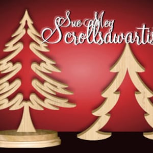 May include: Two wooden Christmas tree cutouts, one with a more intricate design and a base, the other a simpler design. Both are on a red background.