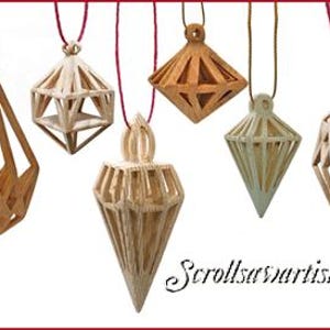 May include: A collection of six geometric wooden pendants of varying shapes and colors, suspended by red or brown cords. The pendants include diamond, cube, and teardrop designs, with a website address in the bottom right corner.