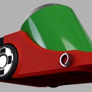 Puede incluir: Un coche de juguete rojo y verde con una rueda negra y un c&iacute;rculo blanco en el centro. El coche tiene un techo verde y un cuerpo rojo.