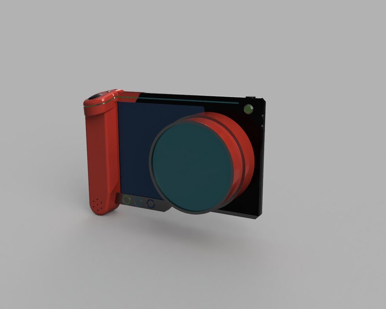 Op de afbeelding: Een rood en zwart handapparaat met een ronde lens en een scherm. Het apparaat heeft een kleine microfoon aan de zijkant.