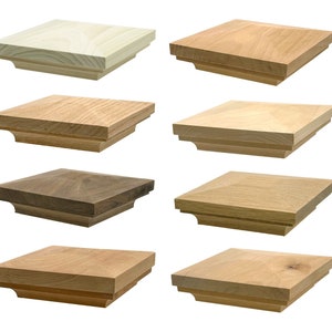 May include: Eight different wooden finials, each with a square base and a slightly raised top. The finials are made of different types of wood, including oak, walnut, and pine.