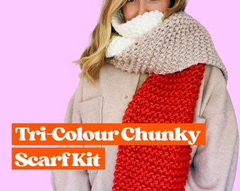 May include: A tri-color chunky scarf kit featuring a red, white, and beige scarf. The scarf is made of chunky yarn and is perfect for keeping warm in the winter.