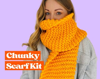 May include: A chunky knit scarf kit in a bright yellow color. The scarf is made with a thick yarn and has a simple, textured stitch pattern.