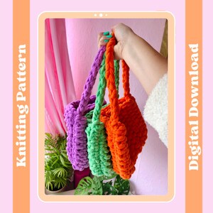 May include: Three crocheted bags in purple, green, and orange. The bags have a chunky texture and are held by a hand.
