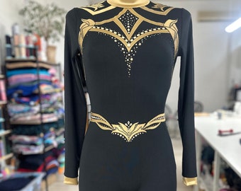 Golden Roman and Egyptian warrior styles mix leotard with rhinestones for aerial performance