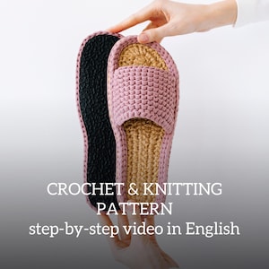 May include: A pair of pink and beige crochet slippers with a black sole. The slippers are being held by a hand. The text "CROCHET & KNITTING PATTERN step-by-step video in English" is visible below the slippers.