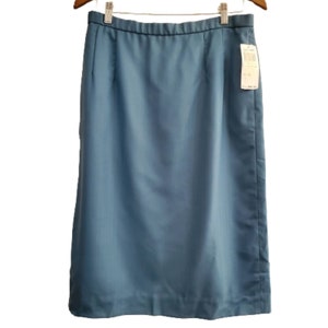 May include: A blue knee-length skirt with a simple design and a straight cut. The skirt has a waistband with a slight elastic feel.