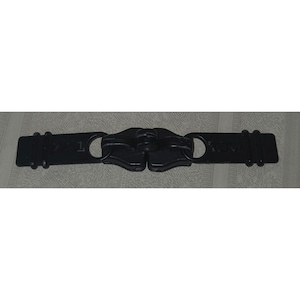 May include: A black zipper with two rectangular ends and a central interlocking mechanism. Each end has a hole and a series of raised ridges. The zipper is designed to connect two pieces of fabric or material.