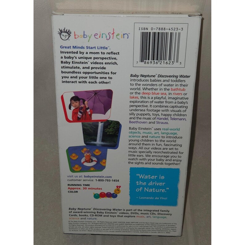 May include: A Baby Einstein "Baby Neptune Discovering Water" VHS video. The rear of the video features text and images, including a child with an umbrella and a cartoon duck. The video runs for approximately 30 minutes.