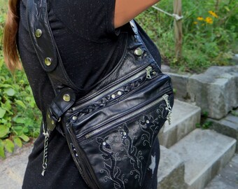 Women's revolver or shoulder bag, in black leather, embroidered curve bag with zip and studs