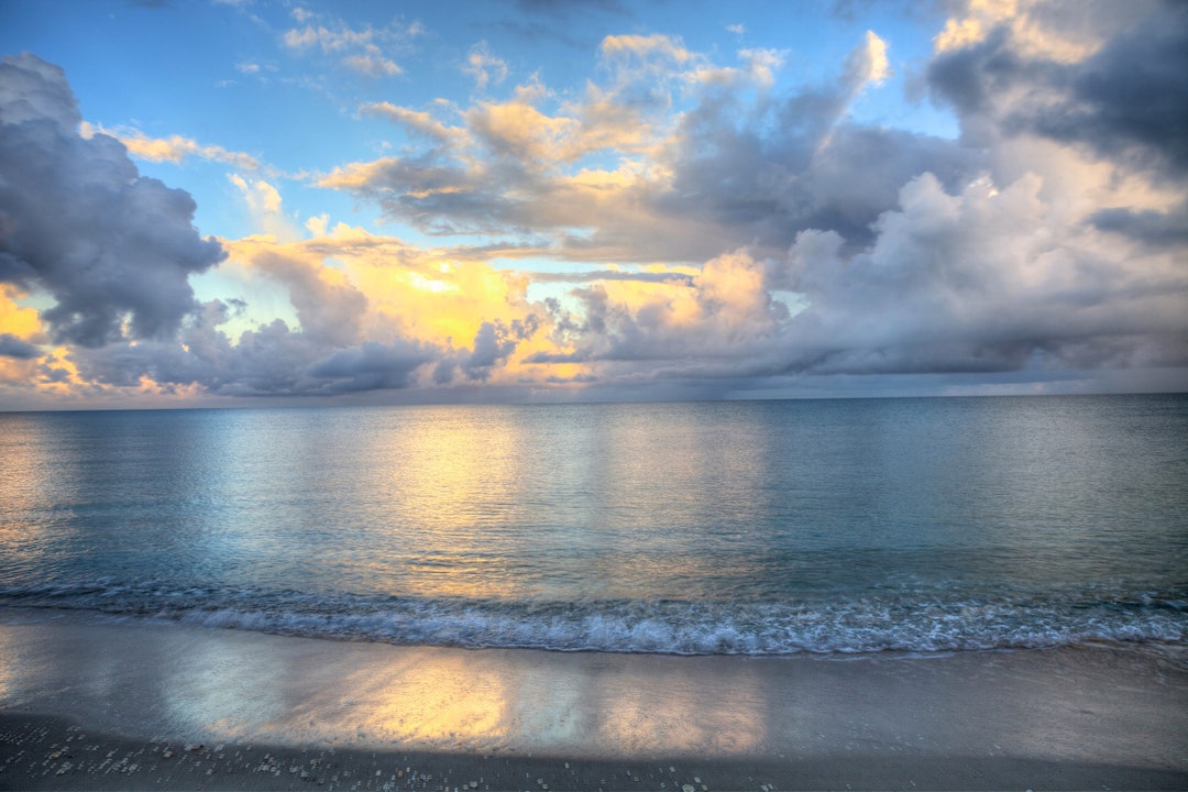 Ocean Rolls in Under Puffy Clouds on North Naples Beach Florida Sunrise