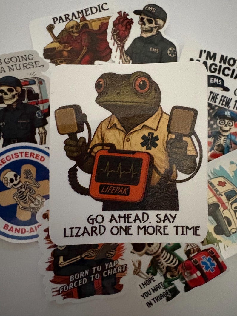 May include: A collection of stickers featuring medical and emergency service themes. One sticker shows a frog paramedic holding a defibrillator with the text "GO AHEAD. SAY LIZARD ONE MORE TIME." Other stickers depict skeletons in EMS uniforms and medical equipment.