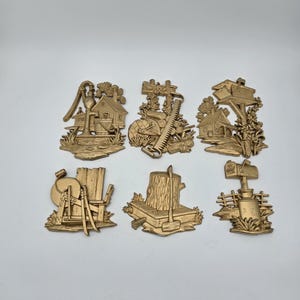 Six piece 1976 Sexton gold metal wall decor