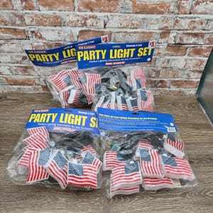 May include: Several packages of 10-light party light sets. Each set features small American flags on a string of lights. The packaging reads "Party Light Set" and "Perfect Lighting Decoration for any Occasion!"