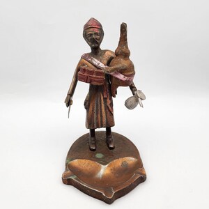 Vintage bronze colored ashtray with man