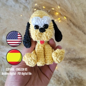 May include: Crochet amigurumi pattern of a yellow and white dog with black ears. The pattern includes instructions for making the dog, as well as the American and Spanish flags.