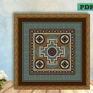 May include: A framed cross-stitch pattern featuring a geometric design in shades of blue, brown, and white. The design incorporates a central cross shape with four smaller squares at each corner.