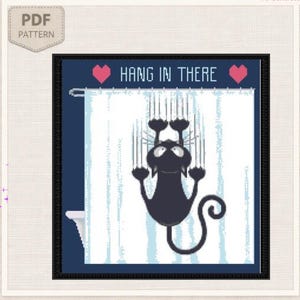 May include: A cross-stitch pattern featuring a black cat clinging to a white shower curtain with vertical blue stripes. The text HANG IN THERE is centred above the cat, flanked by two pink hearts on a dark blue background. A PDF icon is in the corner.