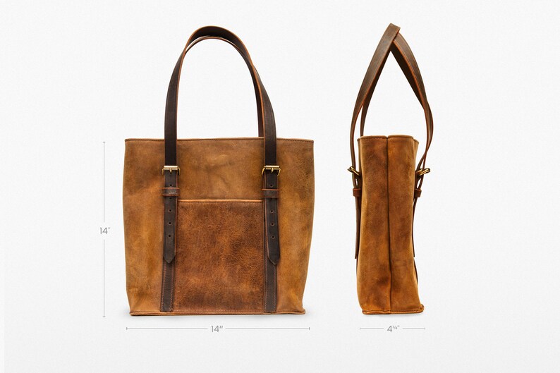 May include: A brown leather tote bag with two adjustable straps and a front pocket. The bag measures 14 inches wide and 14 inches tall.