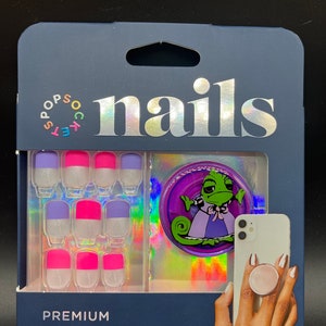 May include: A package of 30 ready-to-wear press-on nails with a pink and purple ombre design. The package includes a prep pad, manicure stick, mini nail file, and a PopGrip phone accessory. The PopGrip features a cartoon chameleon wearing a purple dress.